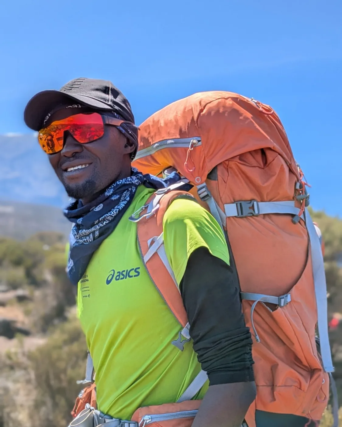 Innocent Chami on the trail on Kilimanjaro, carrying a pack